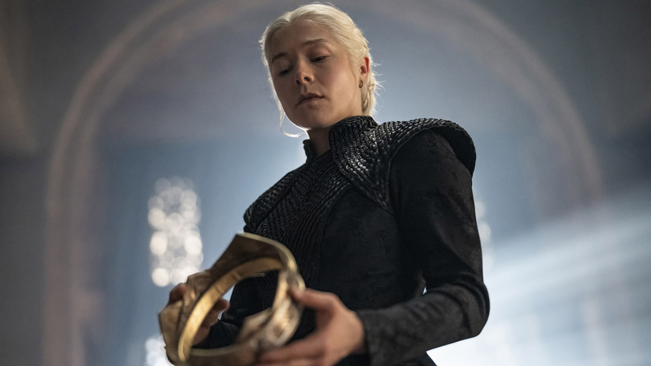 Rhaenyra Targaryen looks down at a gold crown in her hands in House of the Dragon Season 3