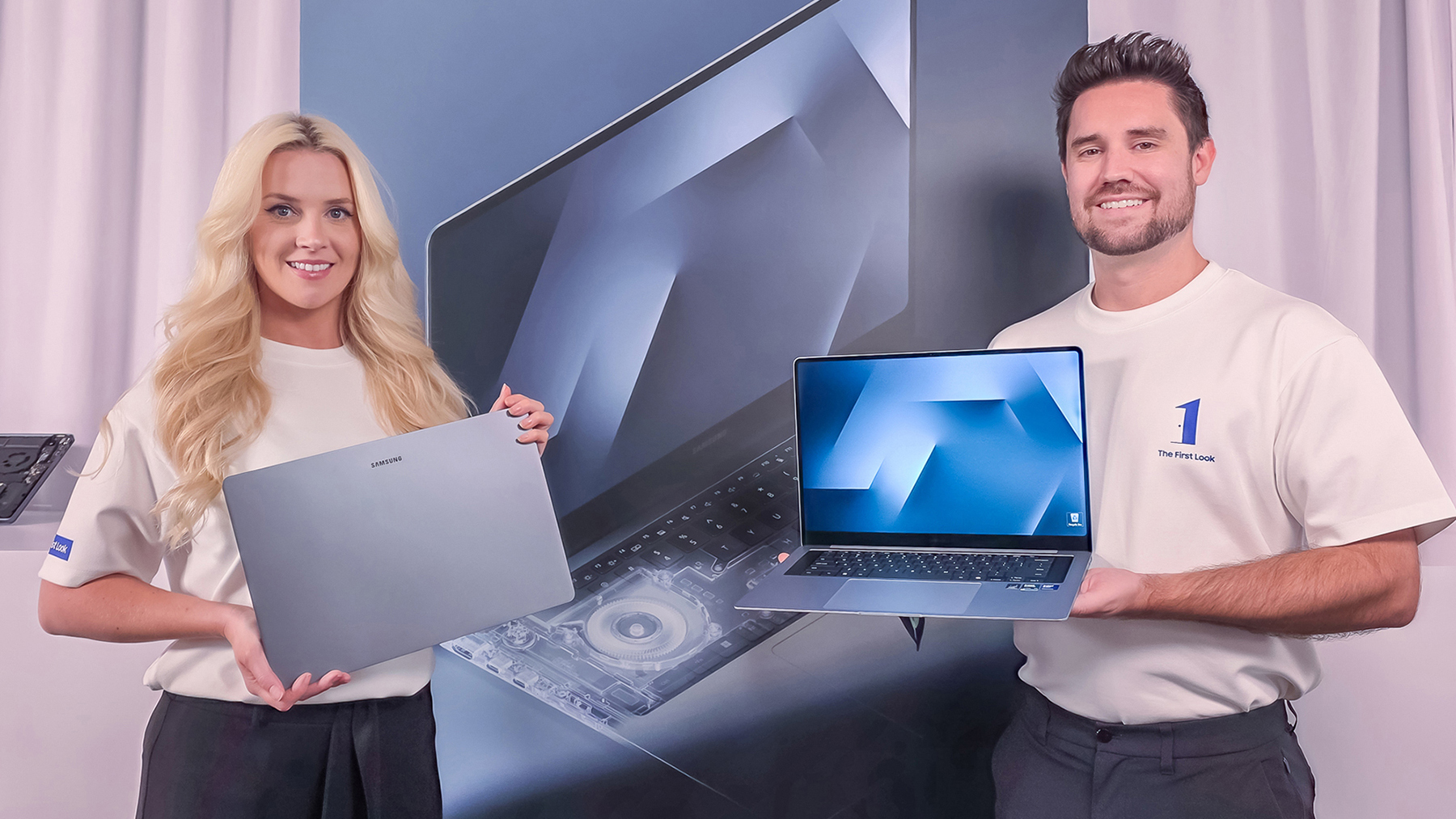 Two people hold up the new Samsung Galaxy Book6 laptop