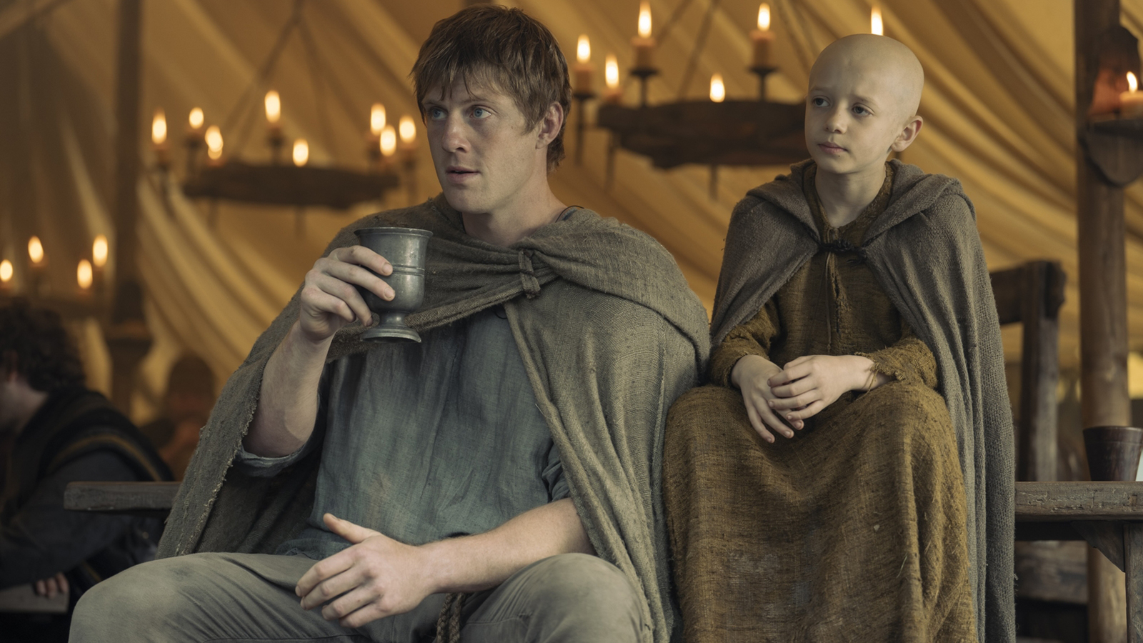 Duncan holds a cup as 'Egg' sits next to him in A Knight of the Seven Kingdoms Season 1