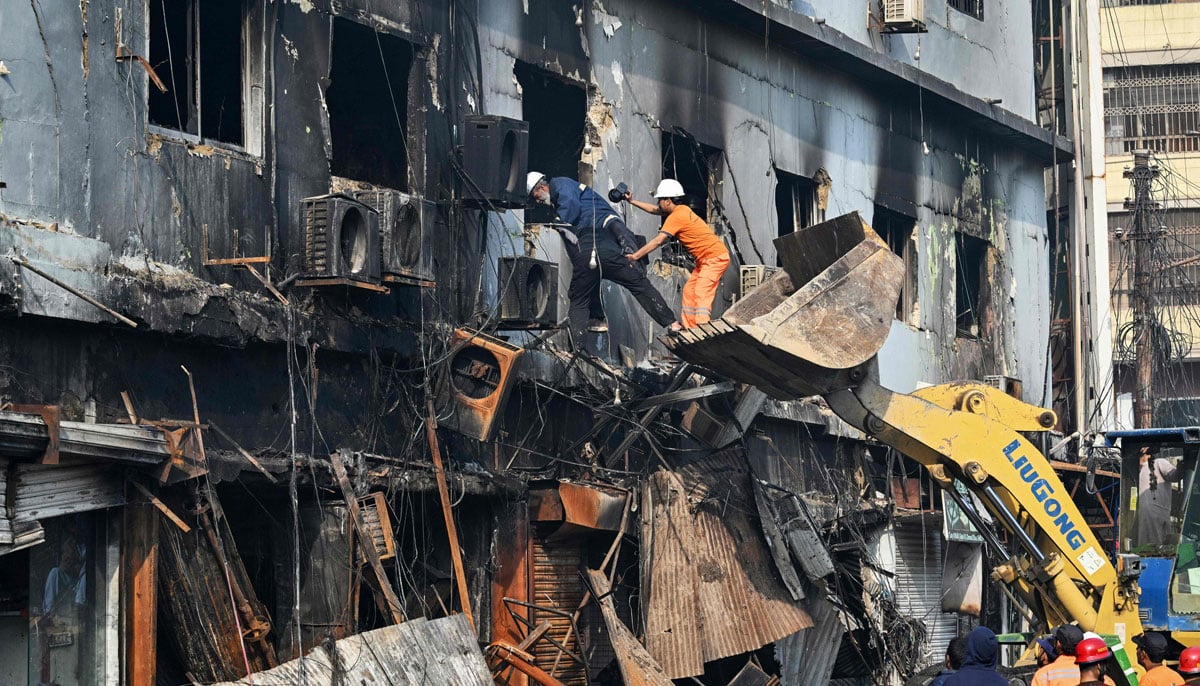 Rescue workers search a burnt structure after a massive fire at a shopping mall in Karachi on January 19, 2026. — AFP