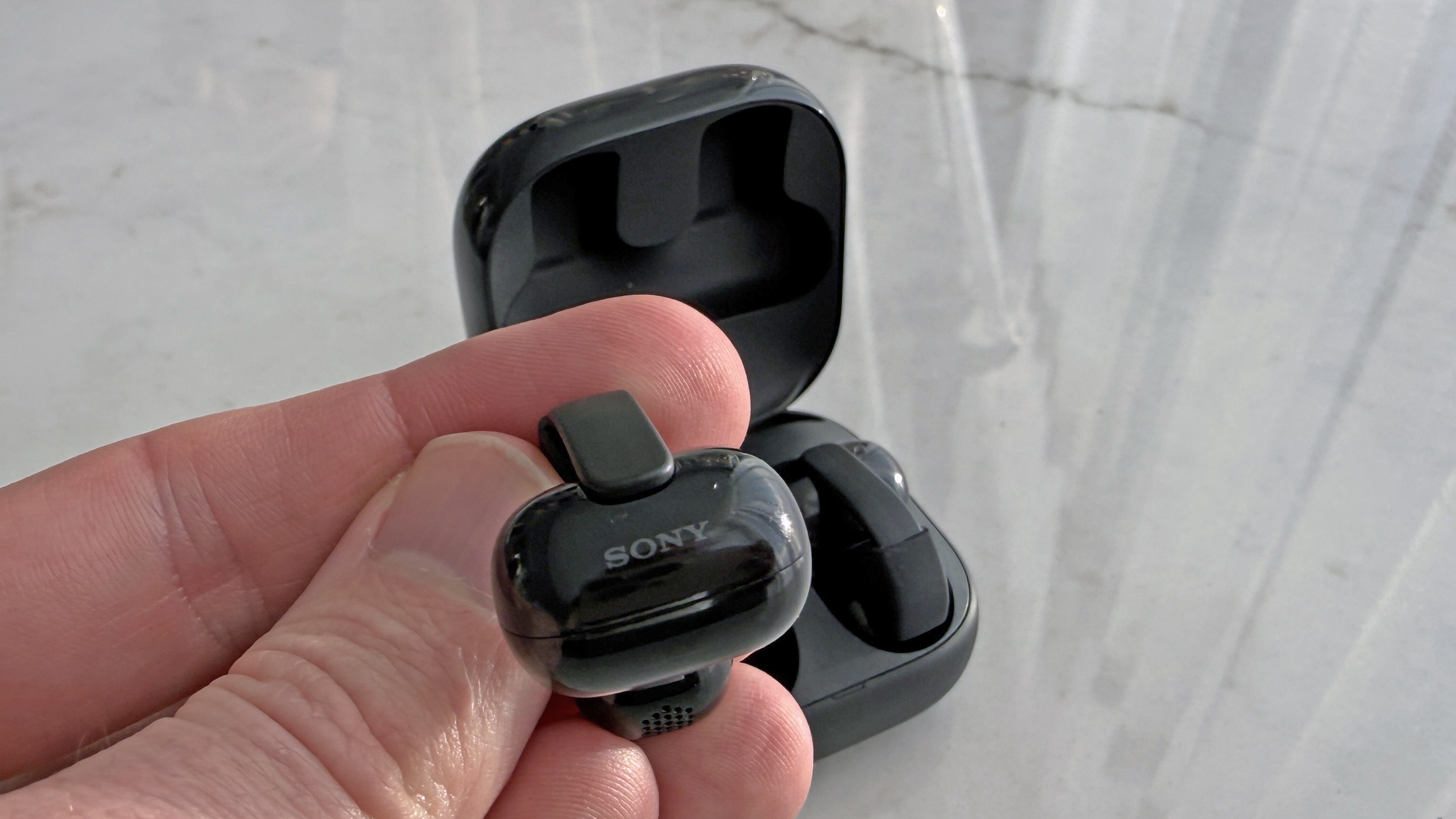 Sony LinkBuds Clip in man's hand showing the Sony logo
