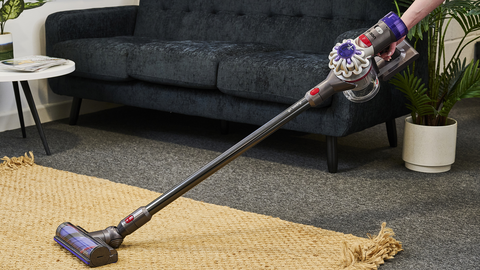 Person using Dyson V8 vacuum cleaner