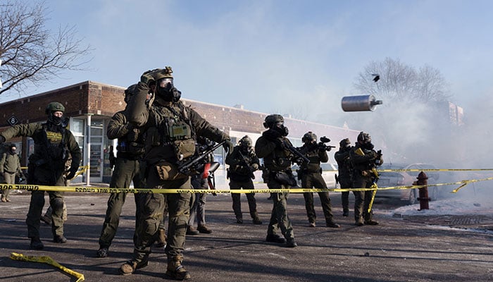 A federal agent throws a tear gas canister near the site where a man identified as Alex Pretti was fatally shot by federal agents trying to detain him, in Minneapolis, Minnesota, United States on January 24, 2026. — AFP