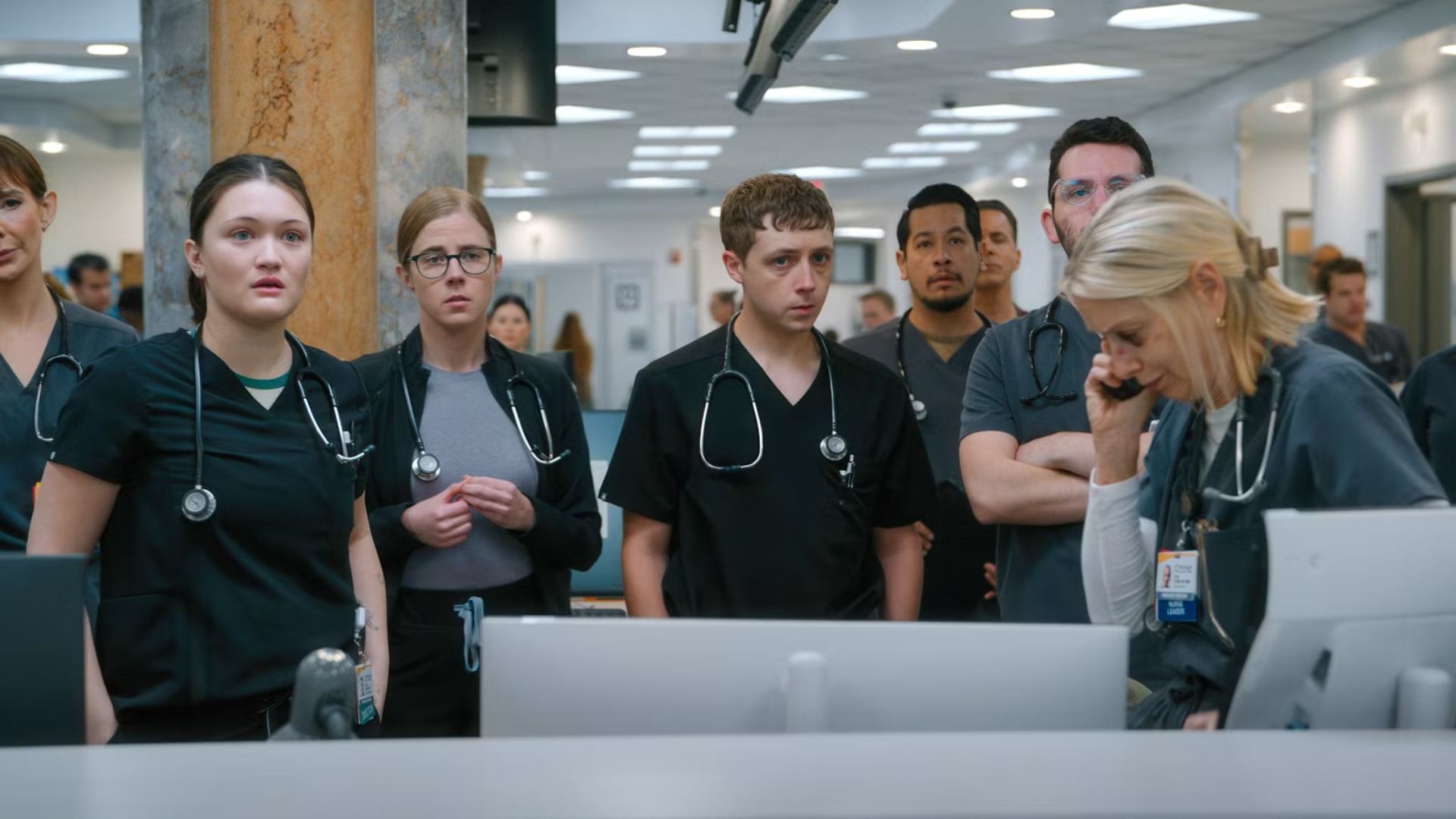 The cast of The Pitt looks at something off-screen