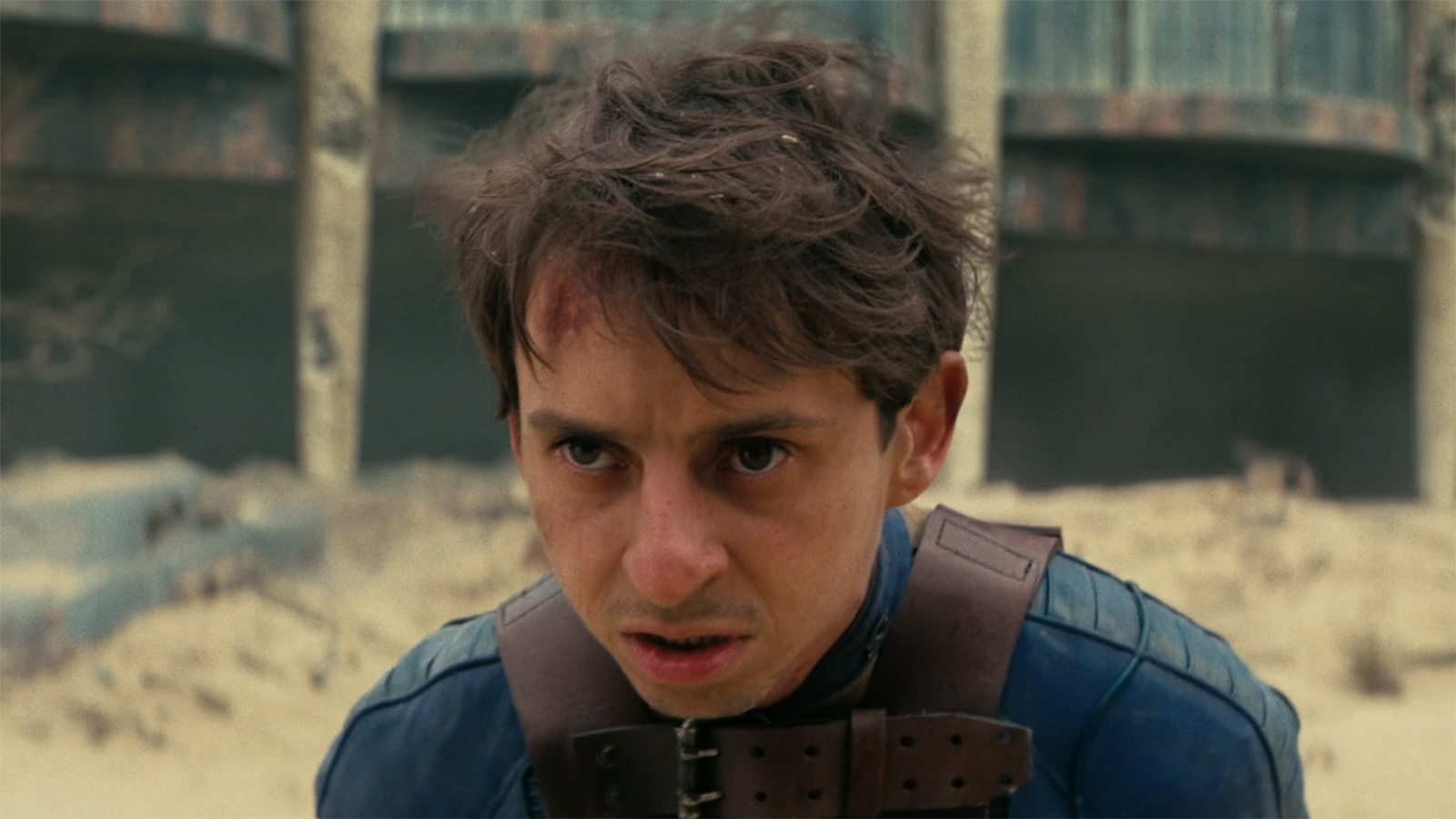 A close-up of a bloody Norm in Fallout Season 2 Episode 8