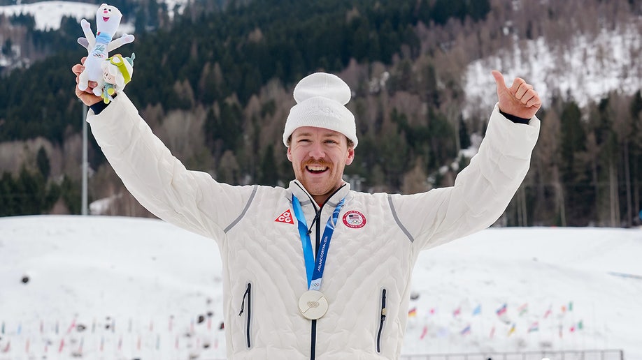 Ben Ogden poses with a silver medal