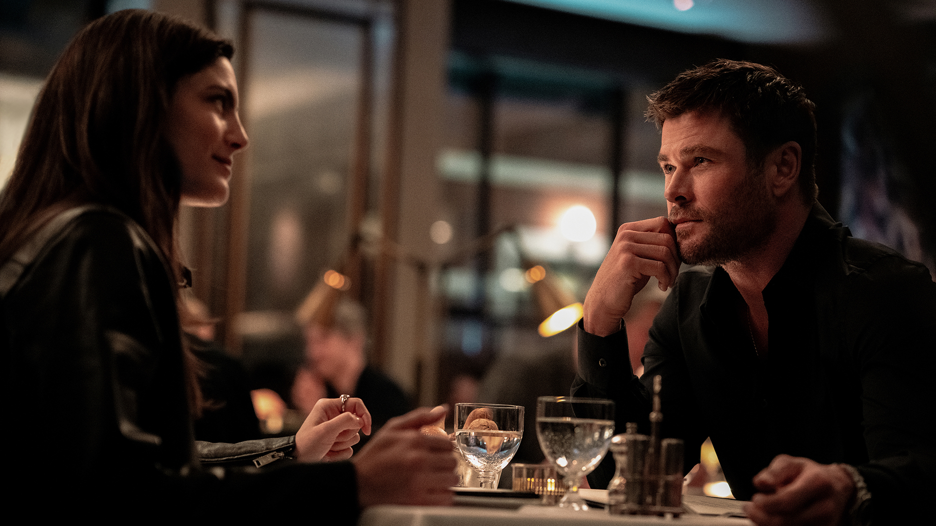 Maya sits across from Davis on a crime 101 date night