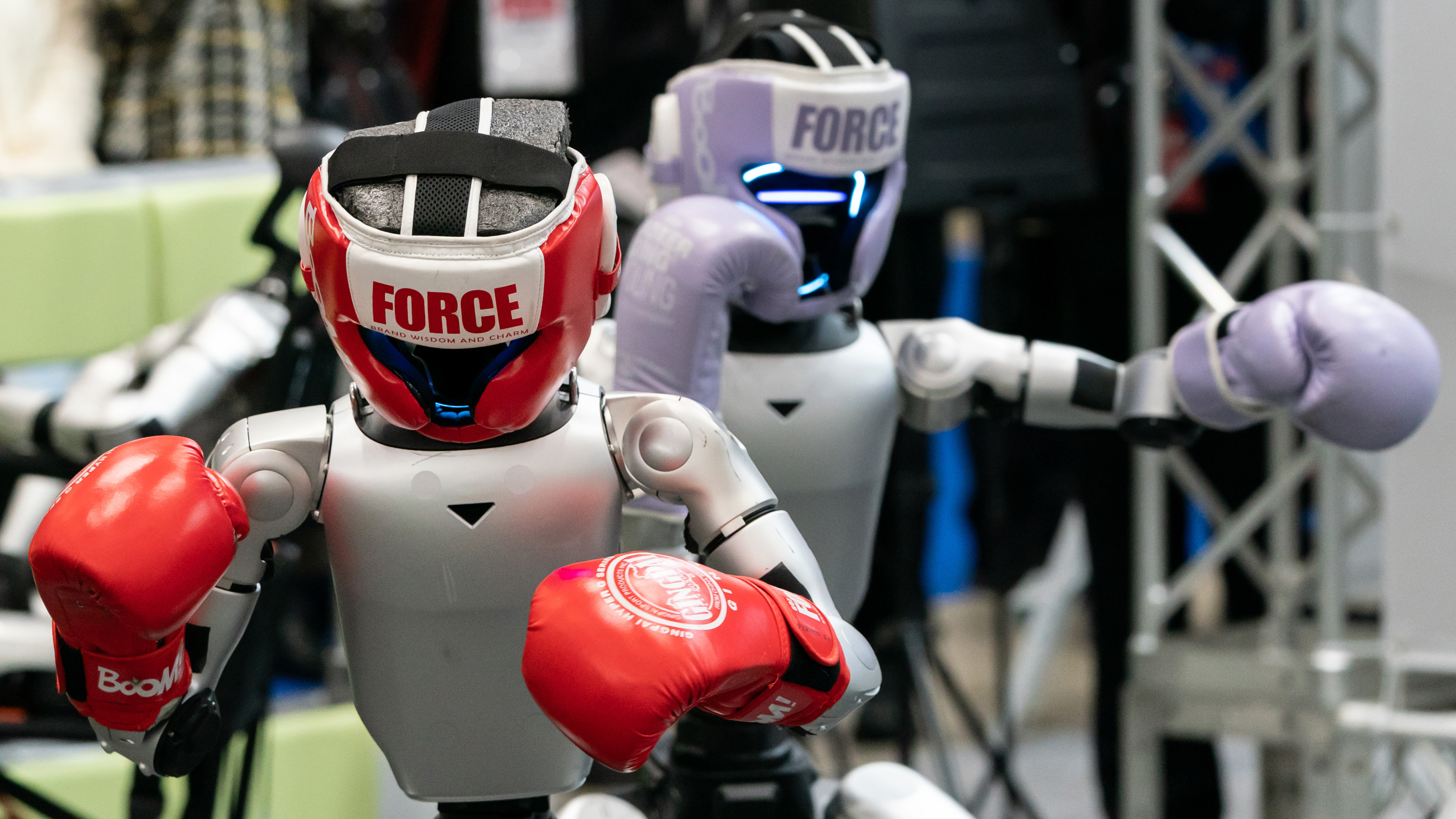 Two Unitree G1 robots in boxing gloves