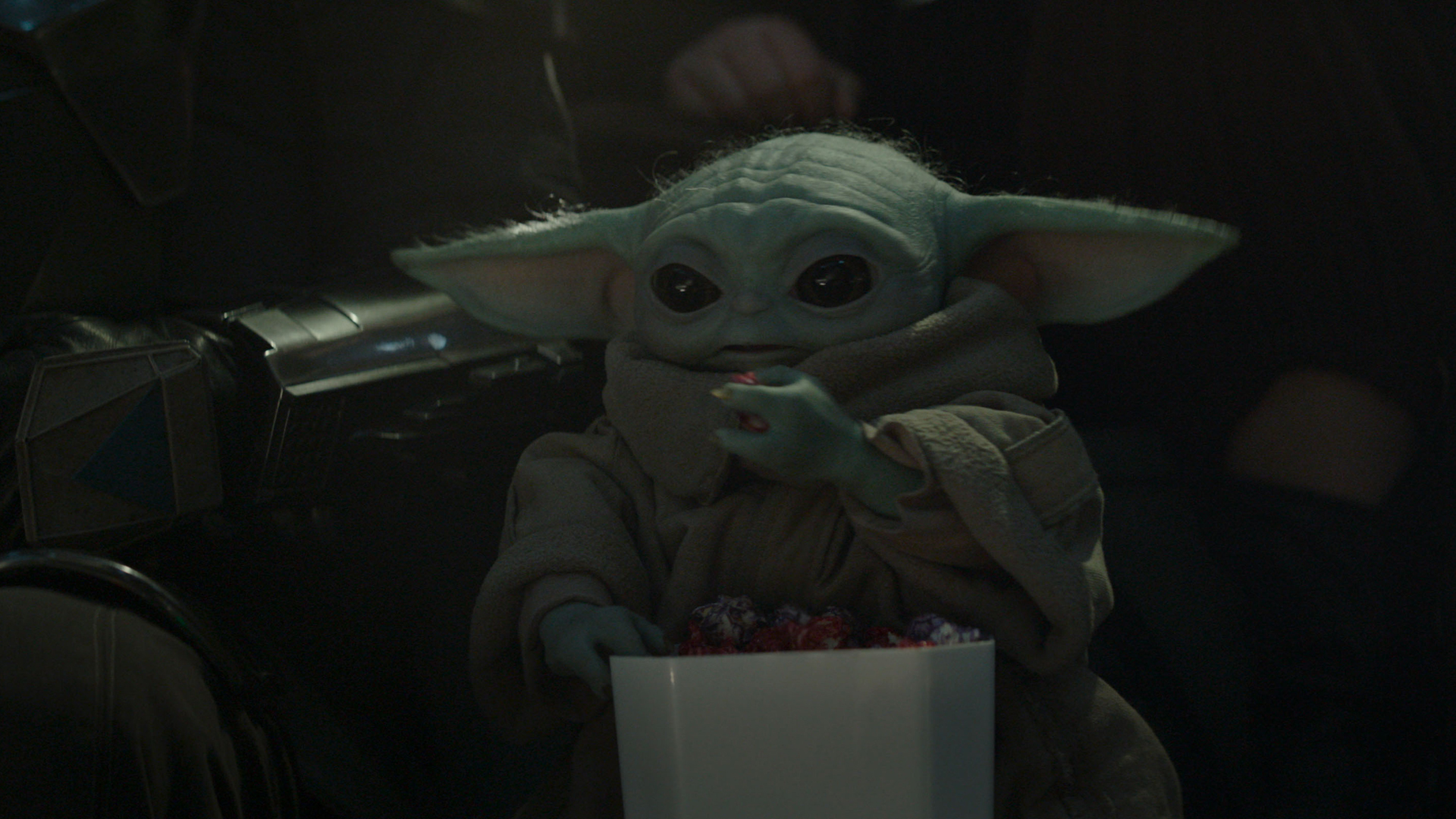 Baby Yoda eats a snack in The Mandalorian and Grogu