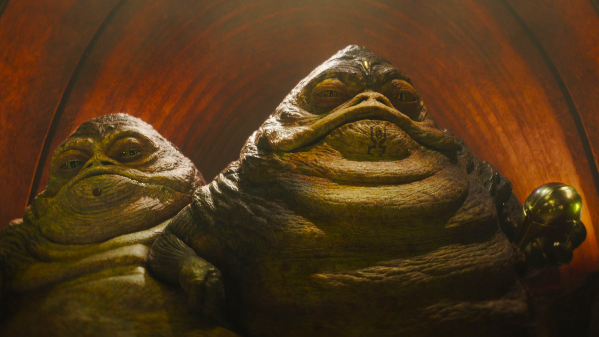 Sister and Brother Hutt look at a Din Djarin off-camera in The Mandalorian and Grogu