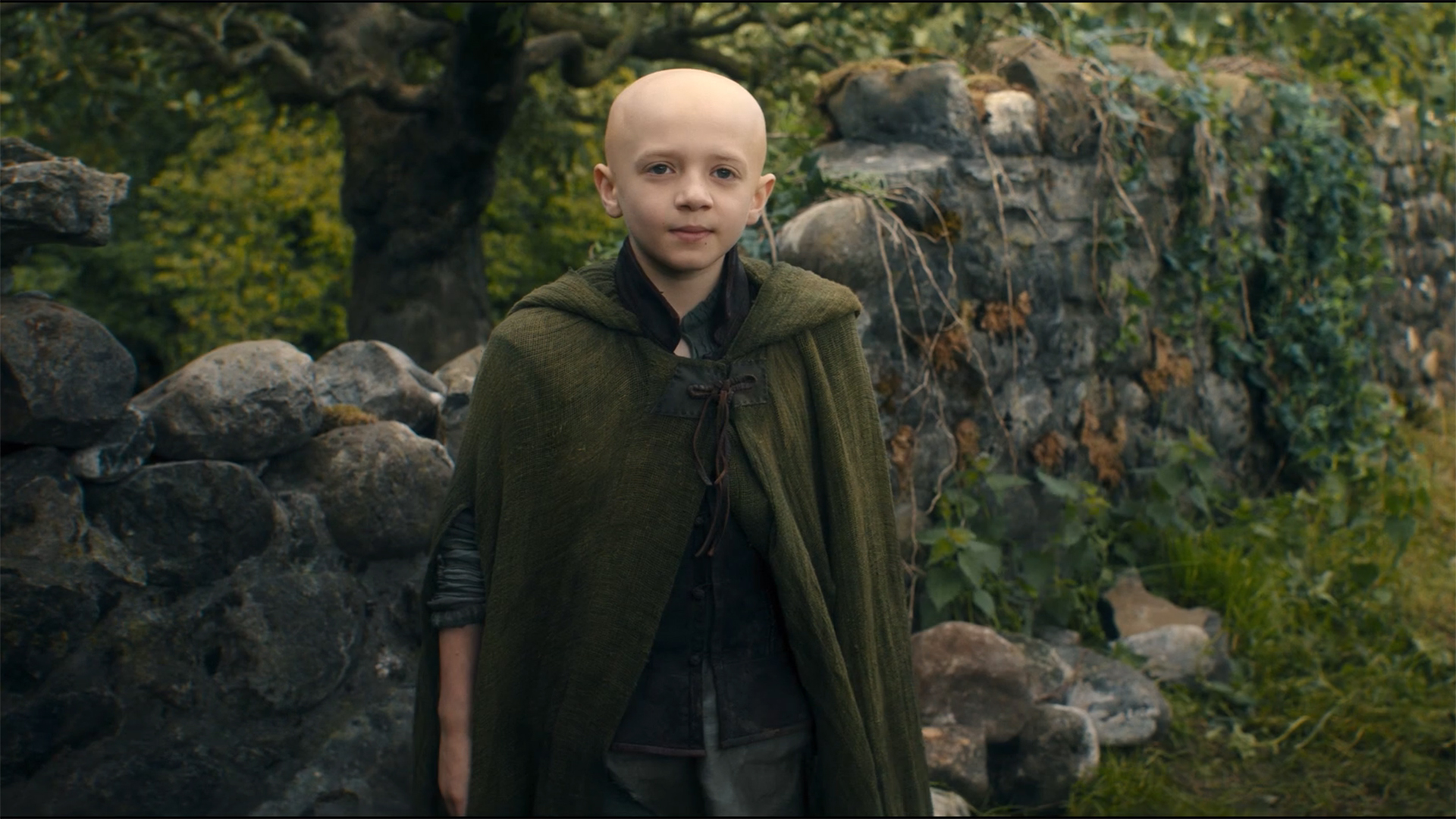 Egg wearing a green cloak and smiling while looking at a can off camera in A Knight of the Seven Kingdoms season 1 finale episode