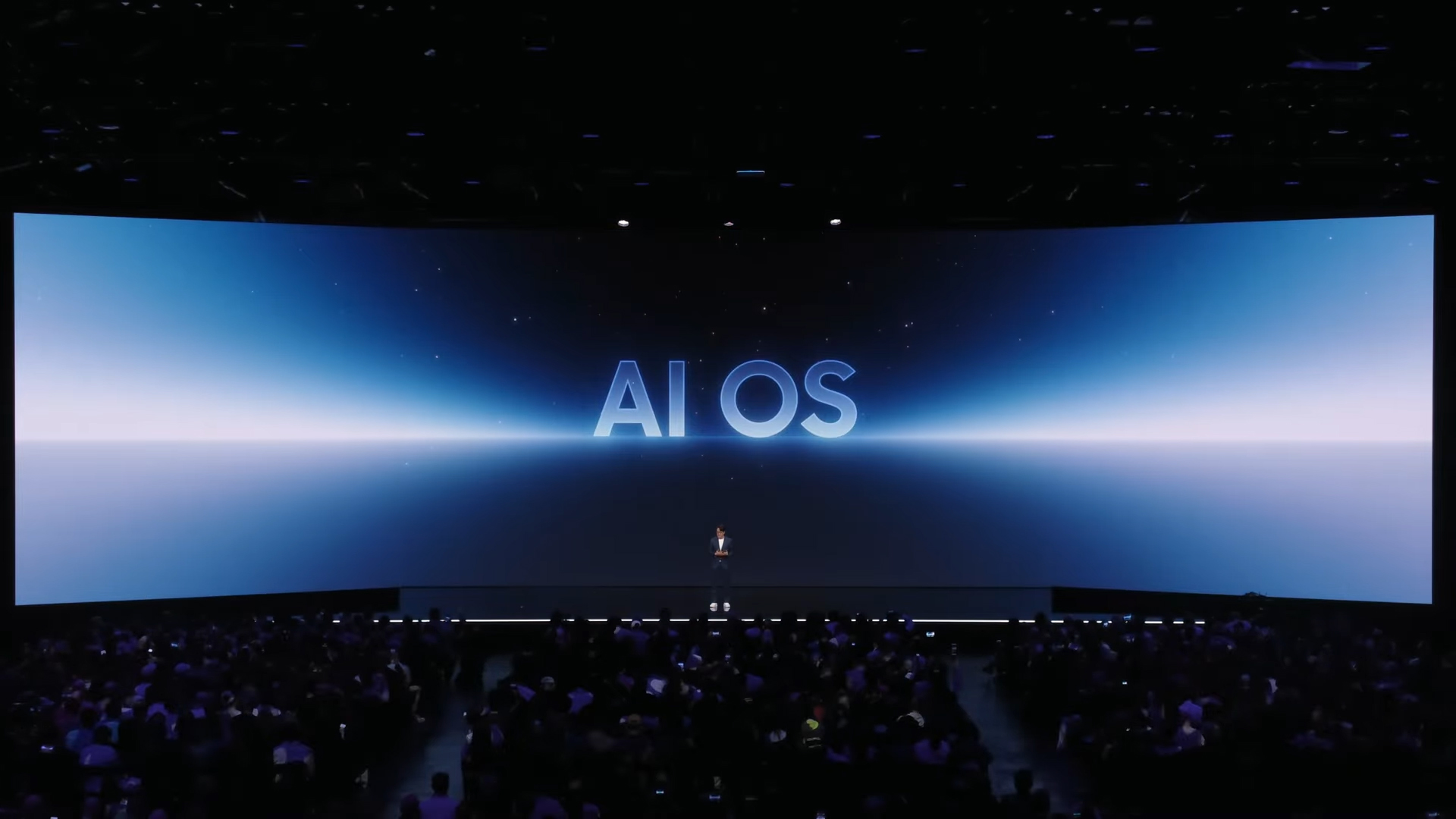 A man on stage at Samsung Galaxy Unpacked talks about AI OS