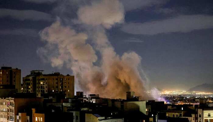 A plume of smoke rises after a missile attack on a building in Tehran on March 1, 2026. — AFP