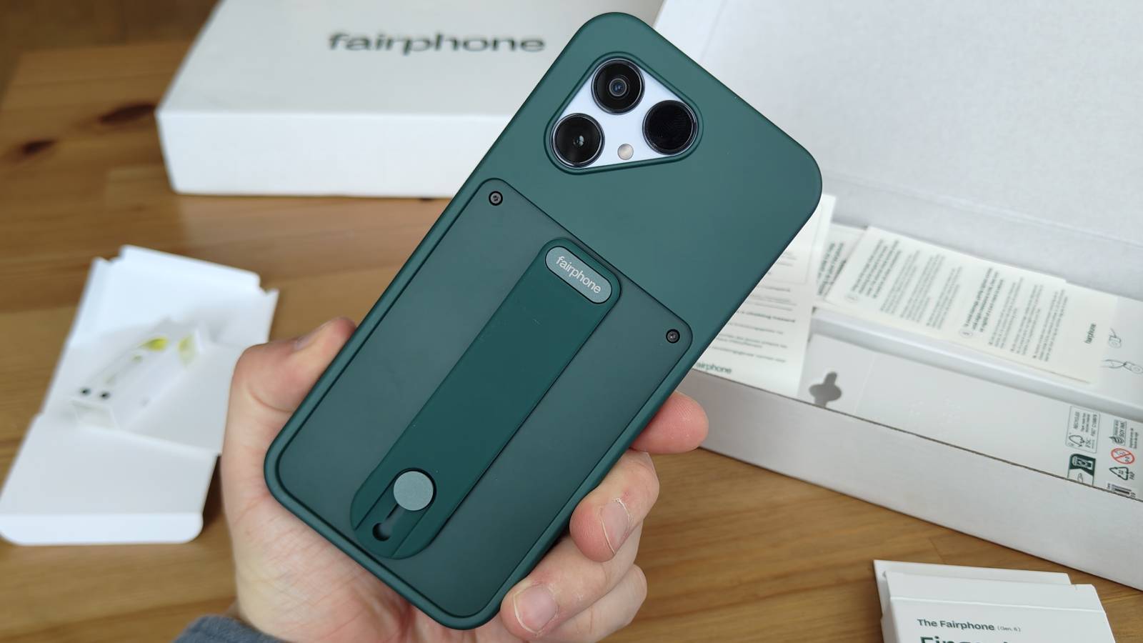 Fairphone 6 with case and finger grip attached.