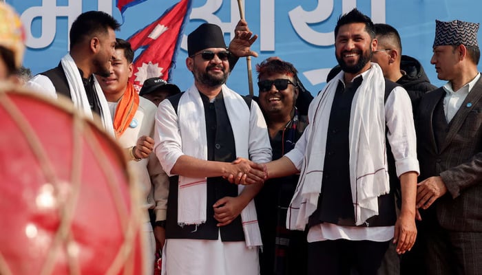 Balendra Shah, former mayor of Kathmandu popularly known as Balen, who party officials say will become prime minister under an internal deal if the Rastriya Swatantra Party (RSP) wins the March 5 election, shakes hands with Rabi Lamichhane, president of the Rastriya Swatantra Party (RSP) during an election campaign in Janakpur, Nepal, January 20269.