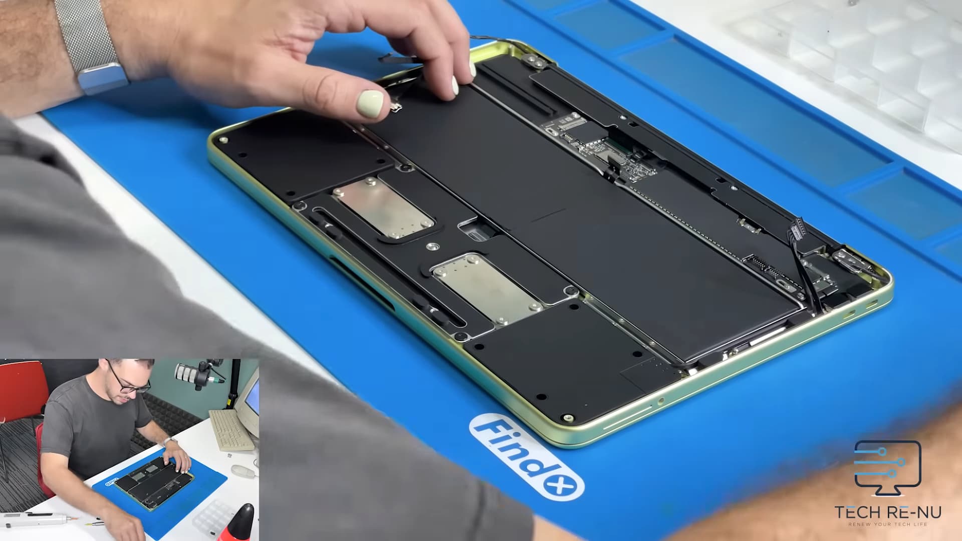 A person from the repair company Tech Re-Nu tears down an Apple MacBook Neo laptop.