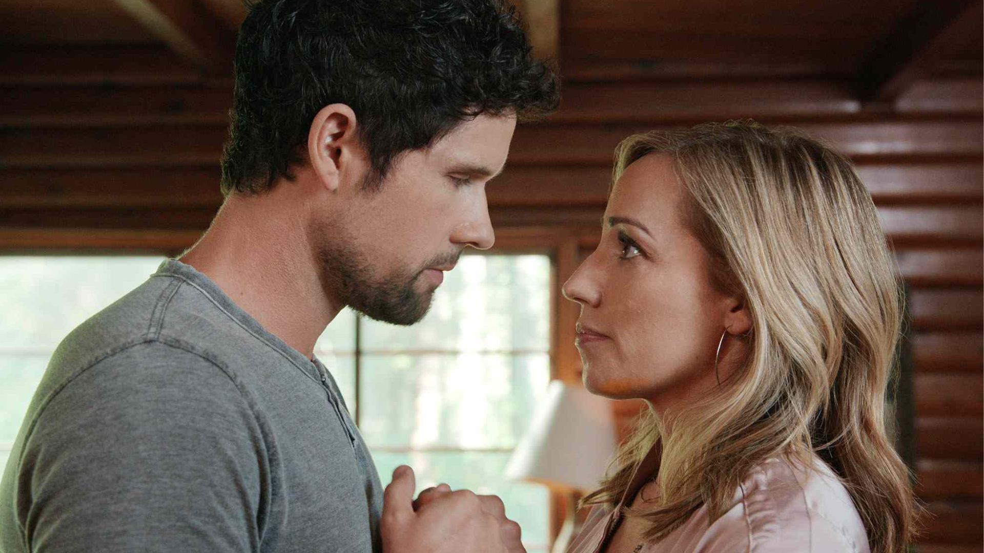 Brady holds Brie's hands as he looks at her