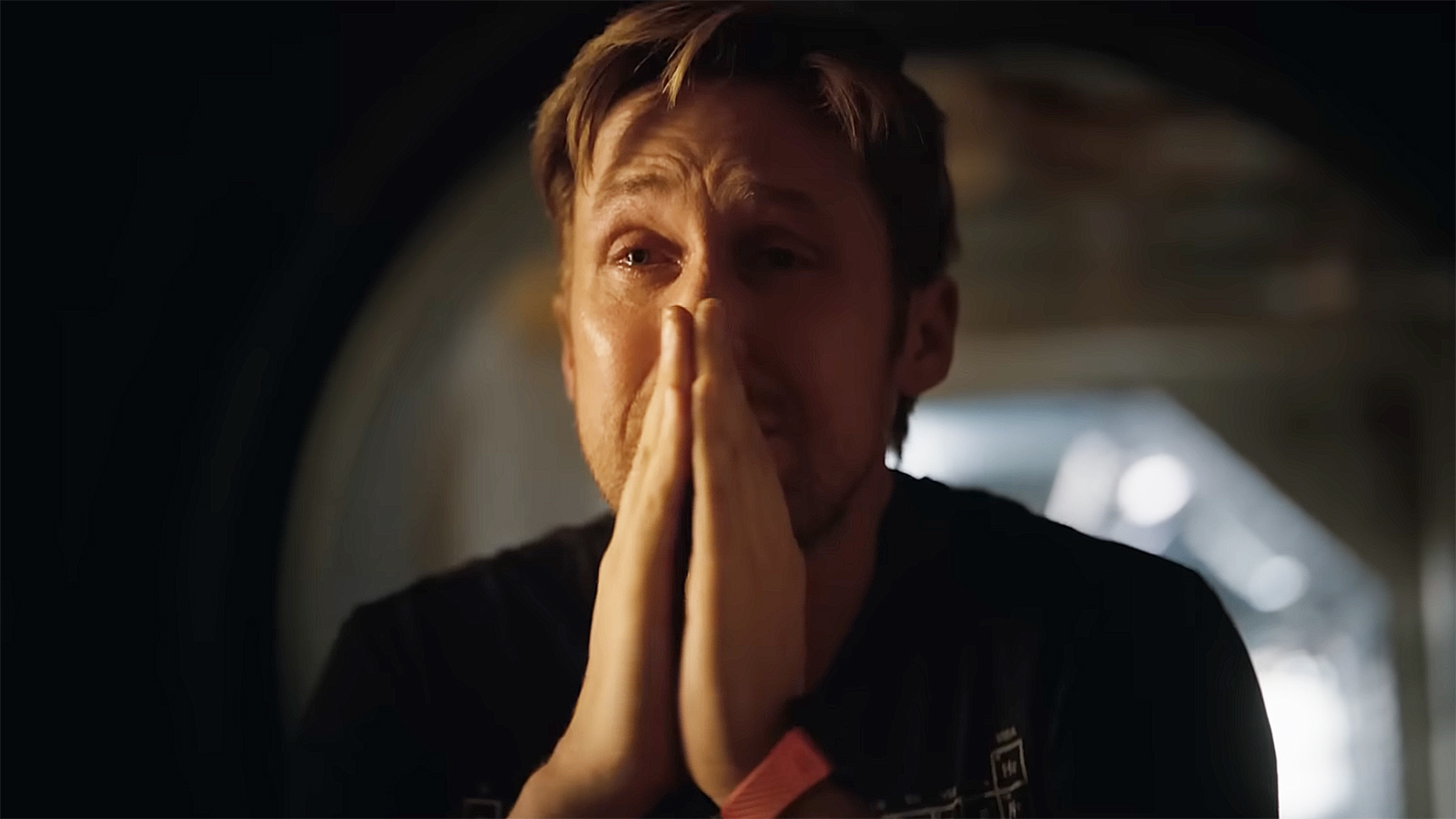 Ryland Grace crying and praying with hands in Project Hail Mary