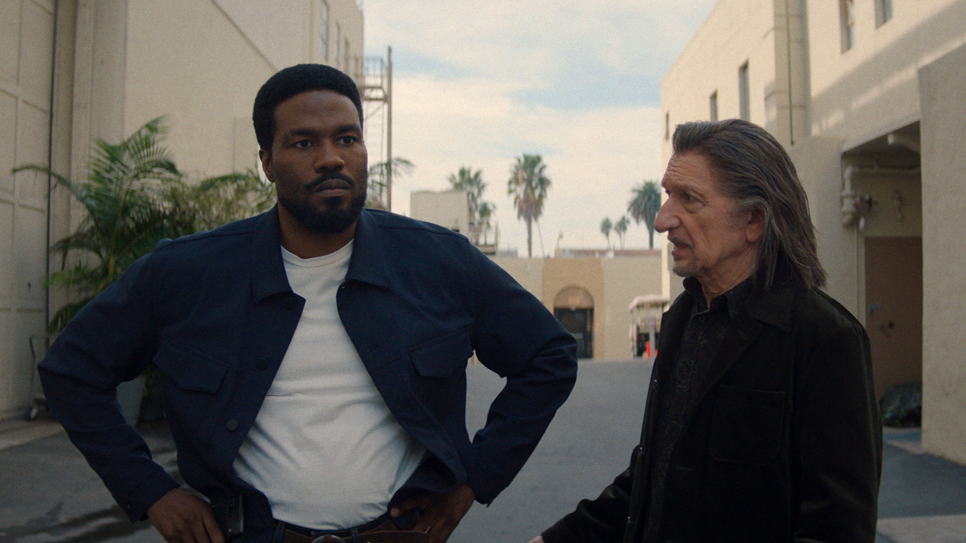 Simon Williams stands with his hands on his hips as Trevor Slattery looks on in Marvel's Wonder Man