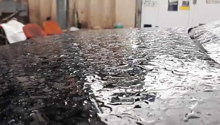 Pearly water droplets rest on a car bonnet in Karachi after heavy showers across the city, April 2, 2026. — Pakinomist News