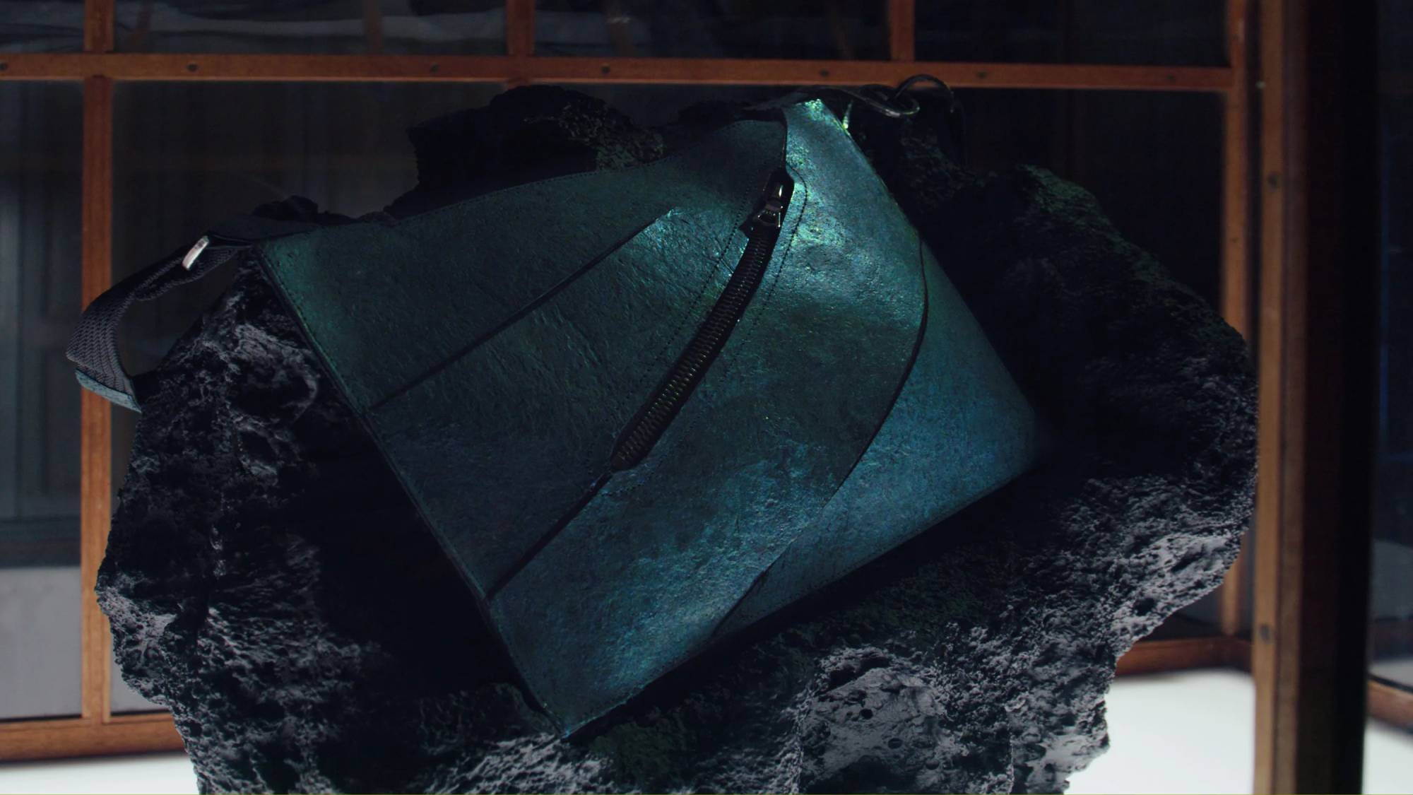 A close-up of the world's first dinosaur leather product in a glass case