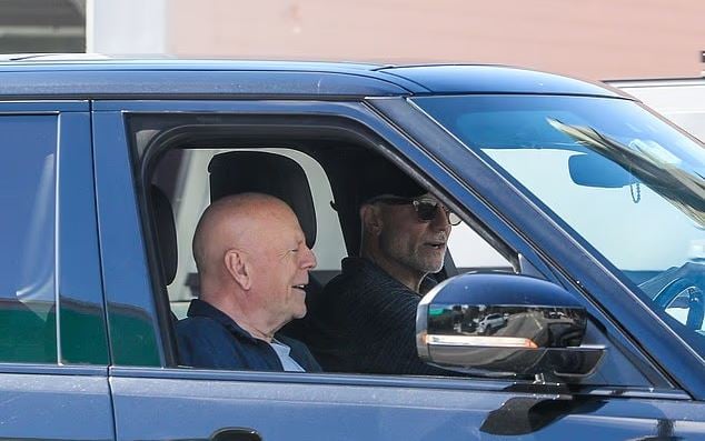 Bruce Willis smiles during a rare LA outing amid a bout with dementia