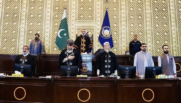 KP Assembly Speaker Babar Saleem Swati (centre) stands for the national anthem before presiding over the session on April 13, 2026. — Facebook/@pakpgov