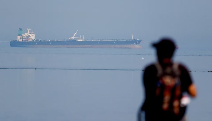 A tourist sees the oil tanker MT Desert Kite carrying Russian oil in the Narara Marine National Park in the Arabian Sea, Gujarat, India, March 11, 2026. — Reuters