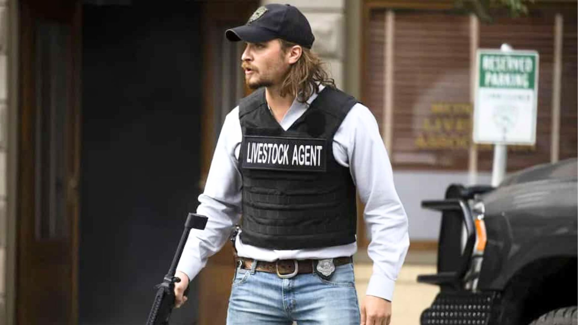 Kayce Dutton wears a livestock agent vest while carrying a gun