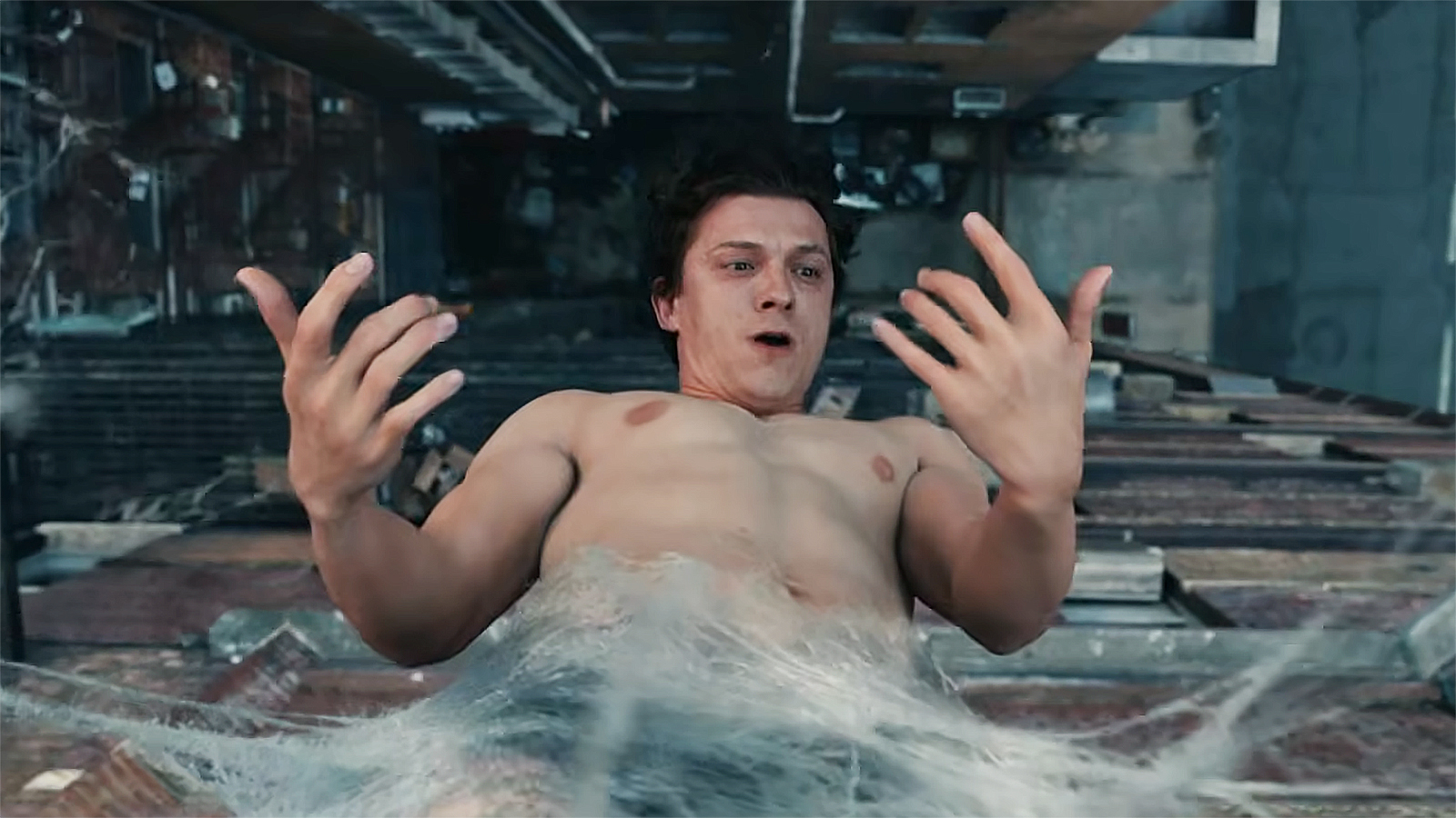 A shocked Peter Parker looks at his hands while hanging upside down inside a web in Spider-Man: Brand New Day