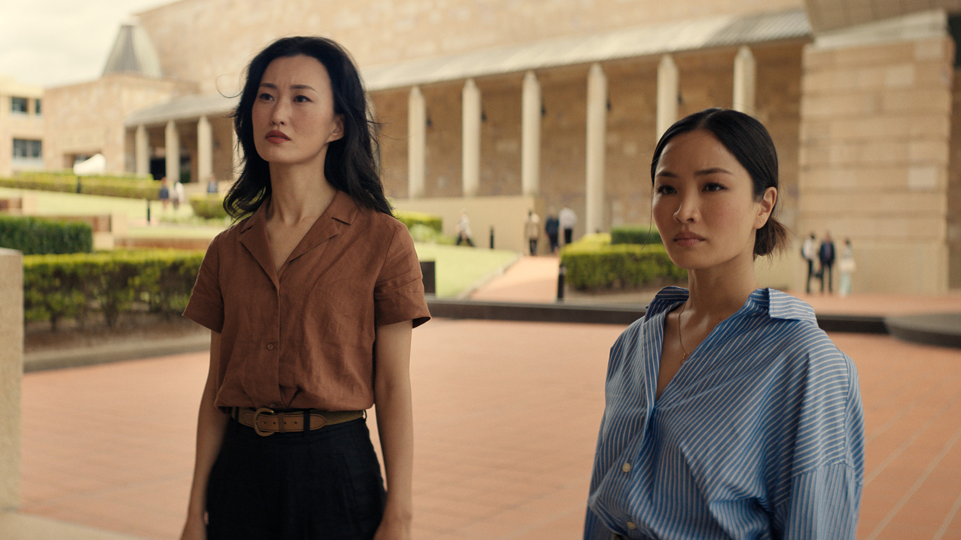 Keiko and Cate stand in a courtyard in Monarch: Legacy of Monsters Season 2 Episode 10