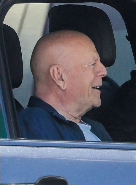 Bruce Willis smiles during a rare LA outing amid a bout with dementia