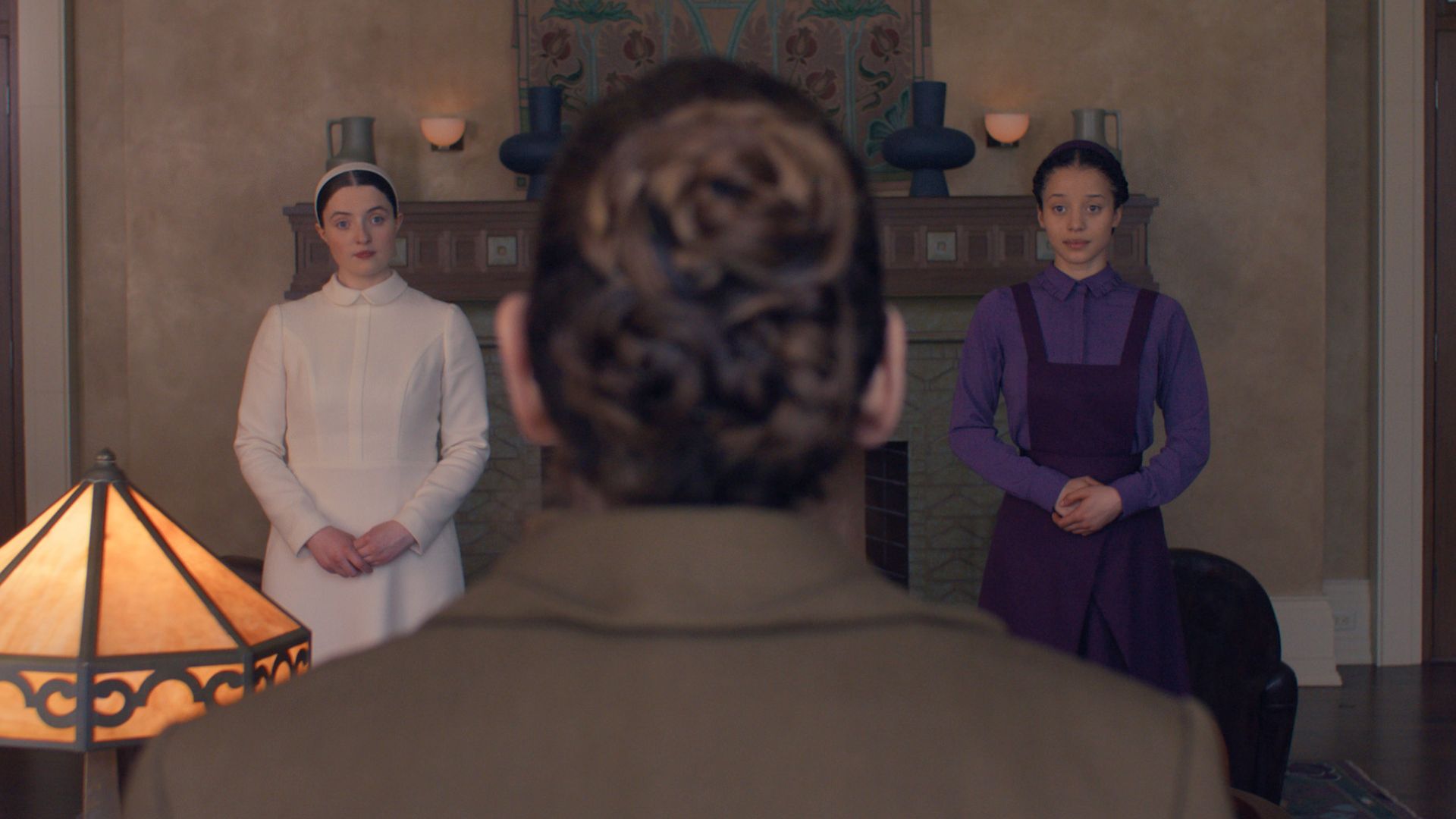 Daisy and Agnes appear on either side of the back of Aunt Lydia's head