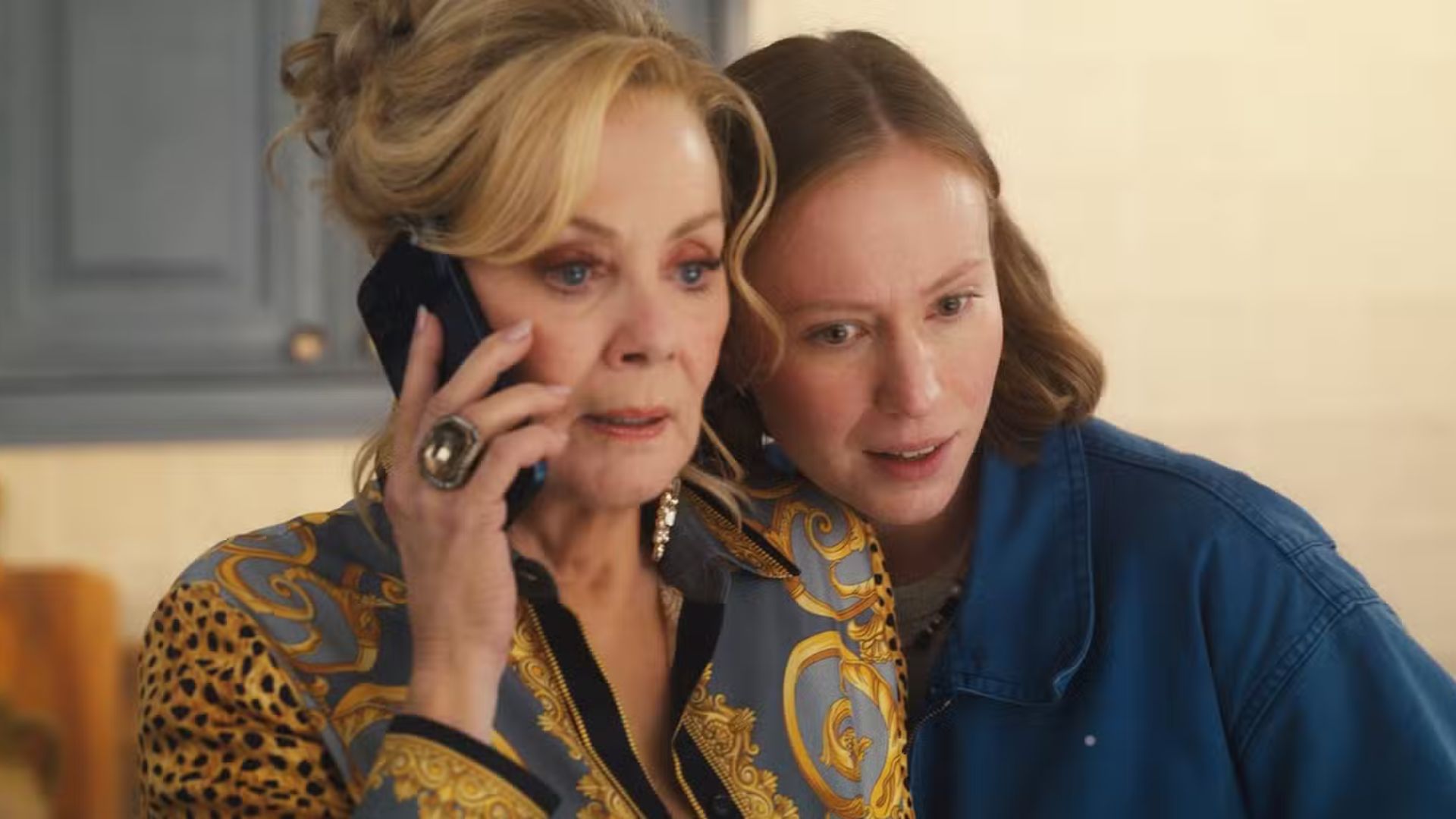 Ava leans into Deborah as she talks on the phone