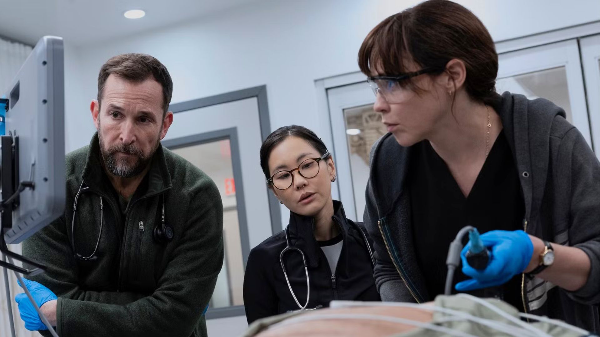 A team of doctors performs an operation on a torso