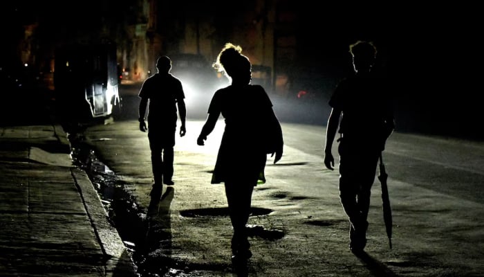 People walk the streets at night as Cuba is hit by an island-wide blackout noise in Havana, Cuba, October 18, 2024. — Reuters