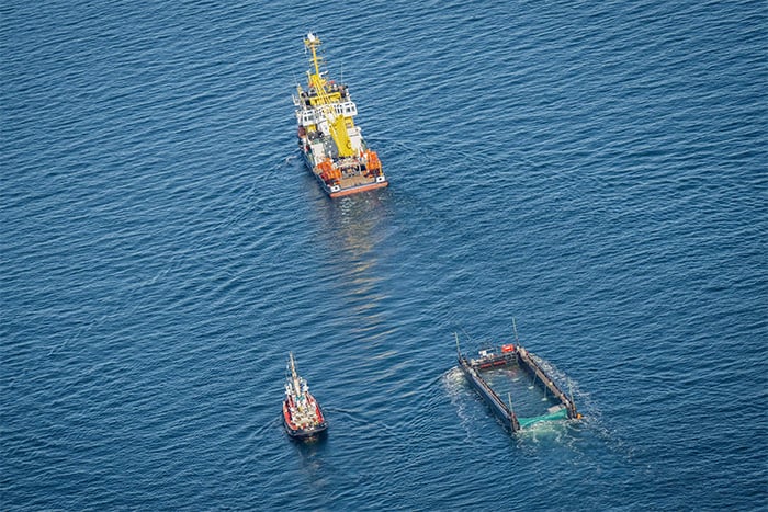 Aerial photo taken on April 29, 2026 shows the rescued humpback whale in a special barge along the Danish coastline on its way back to the North Sea after it ran aground on a sandbank near the city of Lübeck at the end of March. — AFP