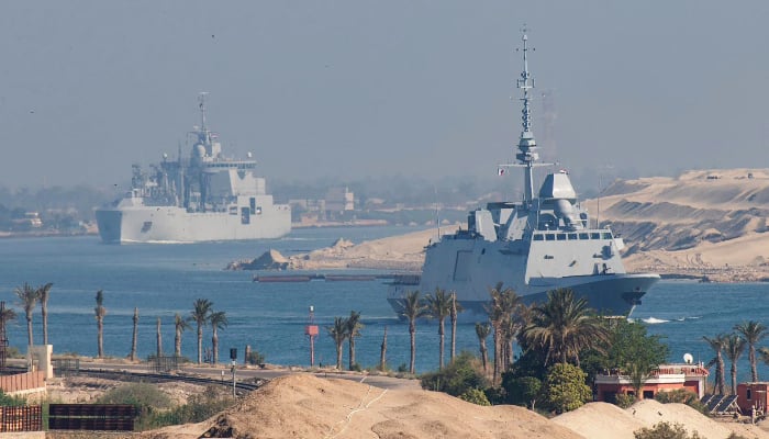 A handout photo released by Marine Nationale (French Navy) on May 6, 2026, shows the French Navy's Carrier Strike Group, which includes the flagship Charles de Gaulle (unseen) and its escort, transiting the Suez Canal en route to the southern Red Sea to prepare for a possible mission to restore navigation in the Strait of Hormuz. — AFP