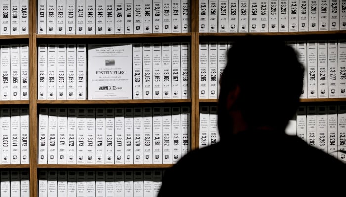 Visitors look at a timeline of events in the Donald J Trump and Jeffrey Epstein Memorial Reading Room, a tribute to the survivors and victims of Epstein's crimes, where 3.5 million pages, 3,437 bound volumes of the Epstein files are displayed in New York City on May 11, 2026. — AFP