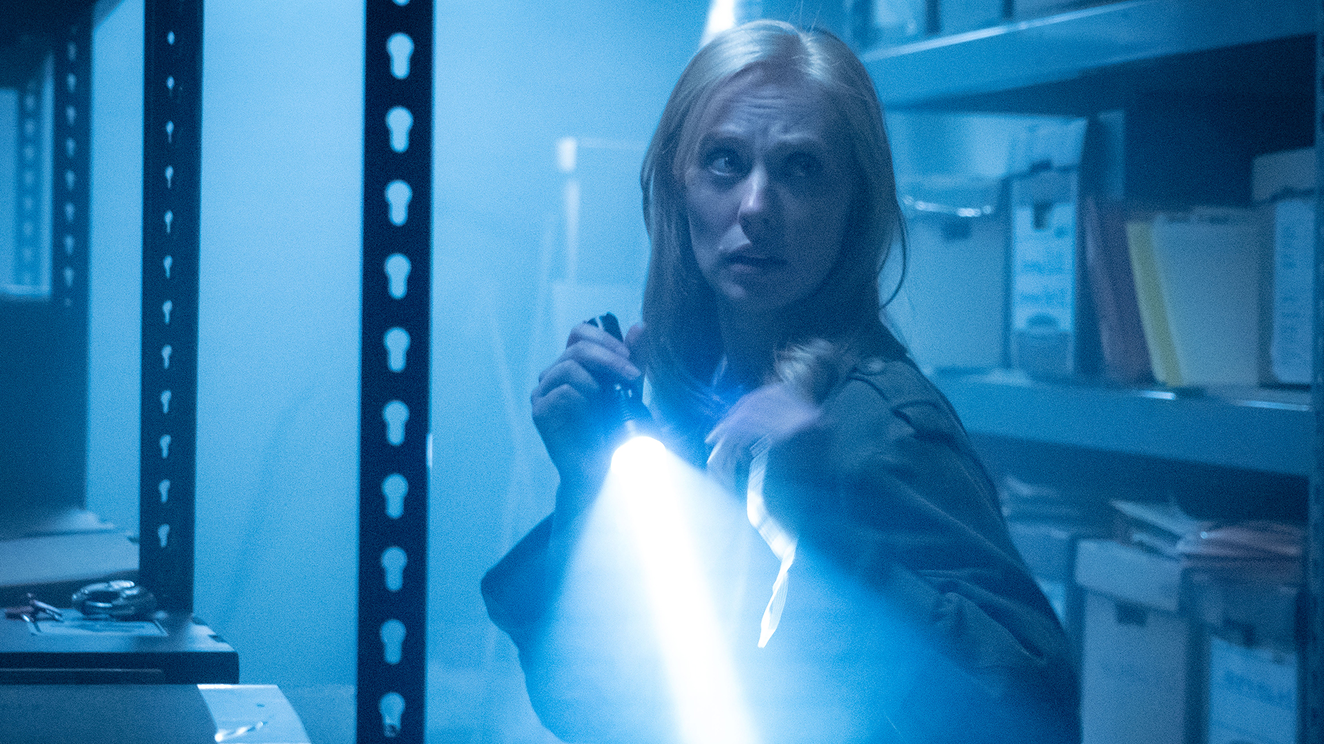 Karen Page in a dark warehouse with a lit torch in Daredevil: Born Again Season 2