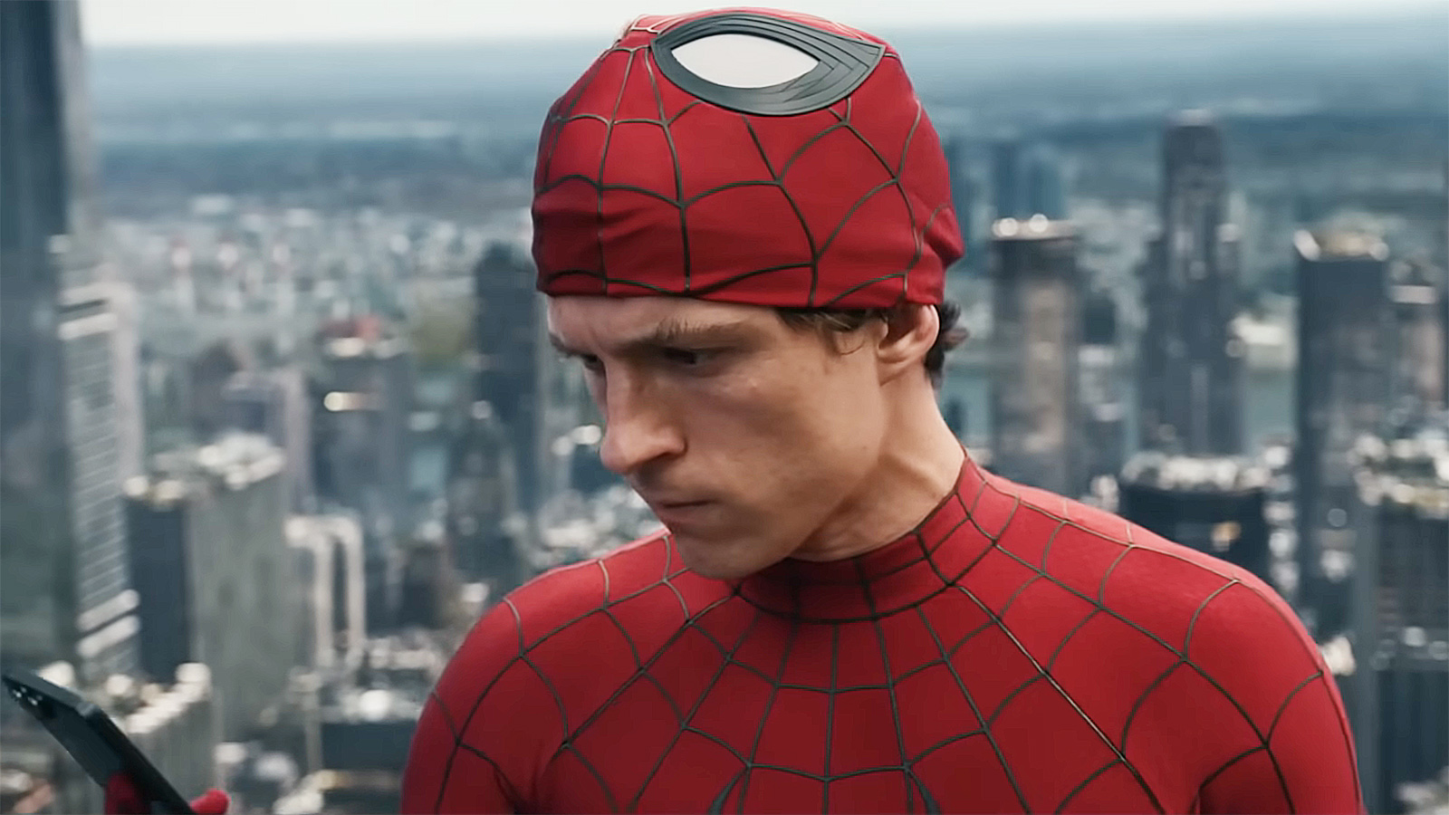 Peter Parker looks at his cell phone with his Spider-Man mask on his head in Spider-Man: Brand New Day