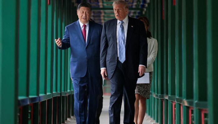 U.S. President Donald Trump takes part in a friendship walk through Zhongnanhai Garden with Chinese President Xi Jinping in Beijing, China, May 15, 2026. — Reuters