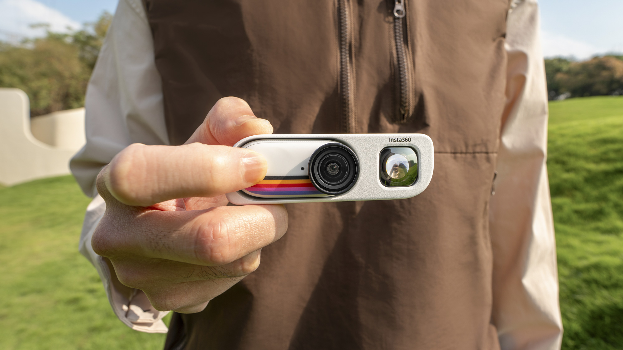 Insta360 Go 3S Retro Edition, with the thumb-sized action camera inserted into the Retro Bundle's viewfinder case, held by a user