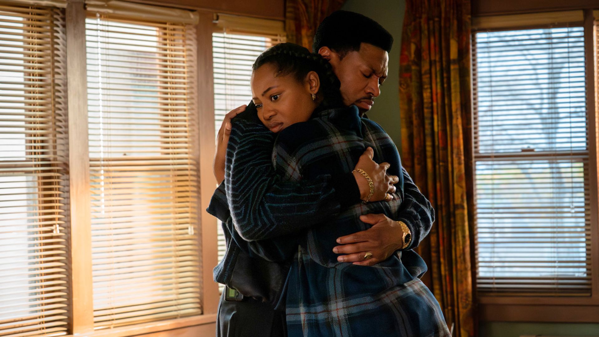 A man and a woman embrace each other in an empty room