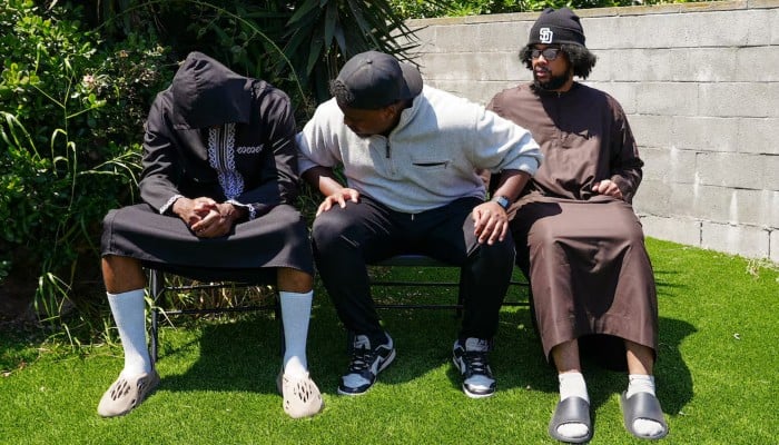Jibril Abdullah, Mohammed Abdullah and Khalid Abdullah, sons of security guard Amin Abdullah who was killed in a shooting incident, sit outside their home in San Diego, California, U.S., May 20, 2026. — Reuters