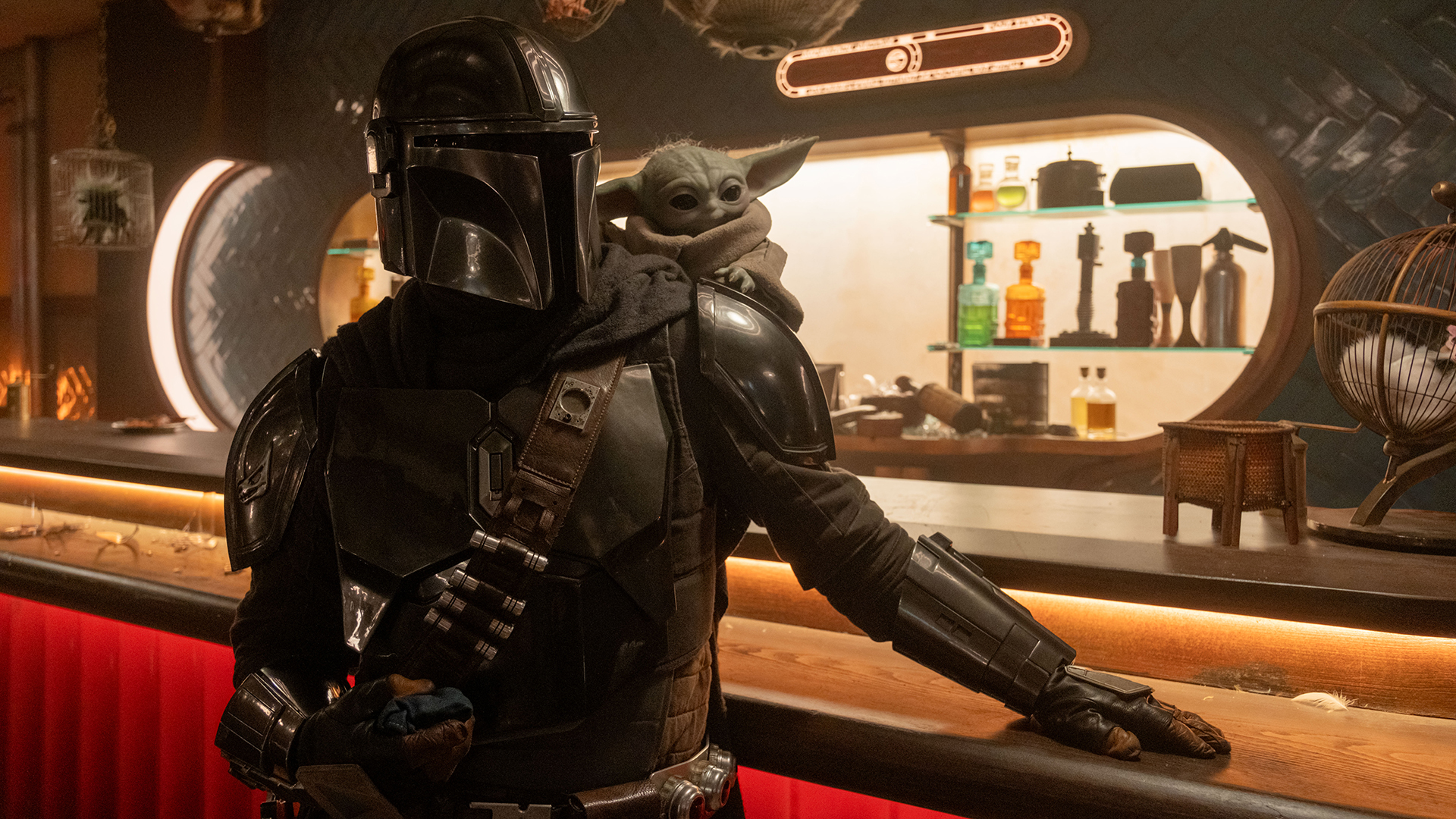 Your Djarin and Baby Yoda are standing in a bar in The Mandalorian and Grogu