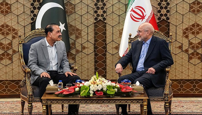 Iranian Parliament Speaker Mohammad Bagher Ghalibaf (R) meets with Defense Chief and Chief of Army Staff Field Marshal Asim Munir in Tehran on May 23, 2026. — Reuters