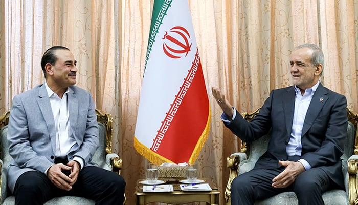 Iran's President Masoud Pezeshkian (R) meets with Defense Chief and Chief of Army Staff Field Marshal Asim Munir in Tehran on May 23, 2026. — Reuters