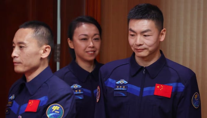 Astronauts Zhu Yangzhu, Zhang Zhiyuan and Lai Ka-ying, who is the first astronaut from Hong Kong, walk to attend a press conference ahead of the Shenzhou-23 space flight mission to China's Tiangong space station, at the Jiuquan Satellite Launch Centre, near Jiuquan, Gansu province, China, May 20, 26.