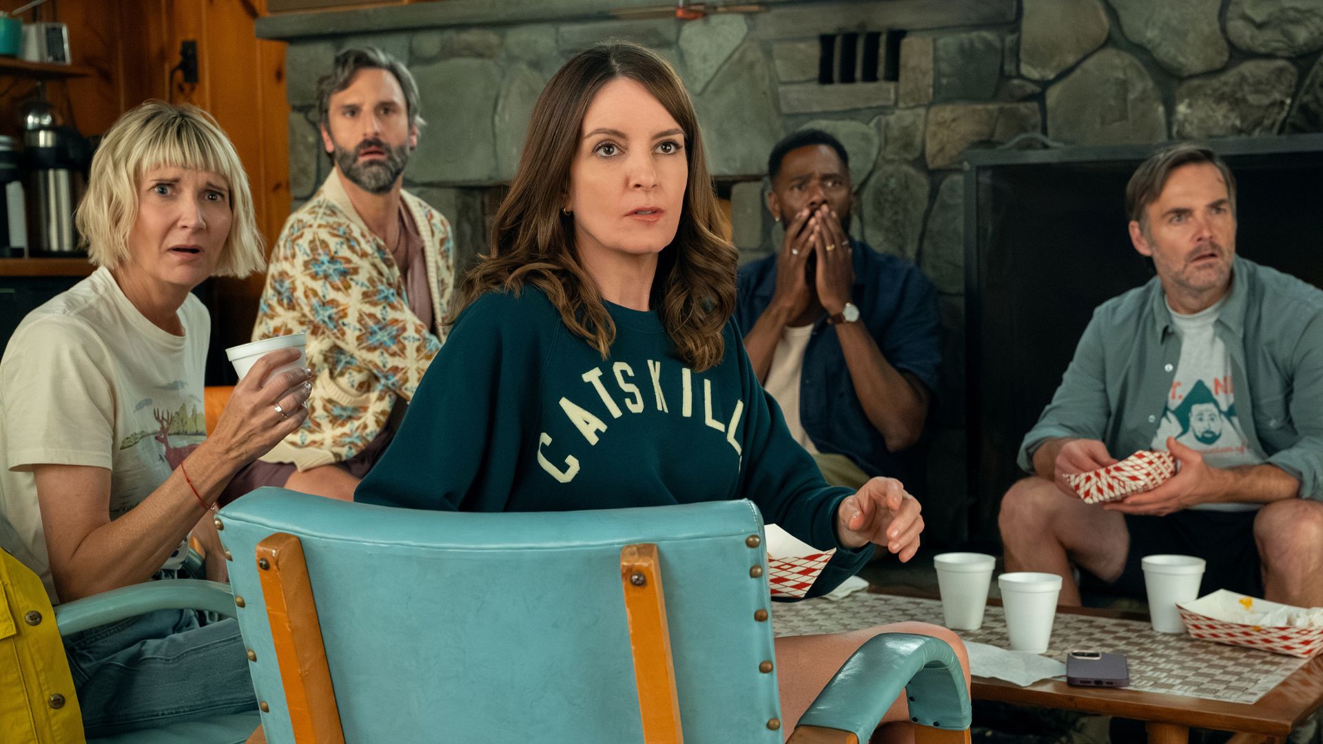 Cast members from The Four Seasons look shocked at something across the room